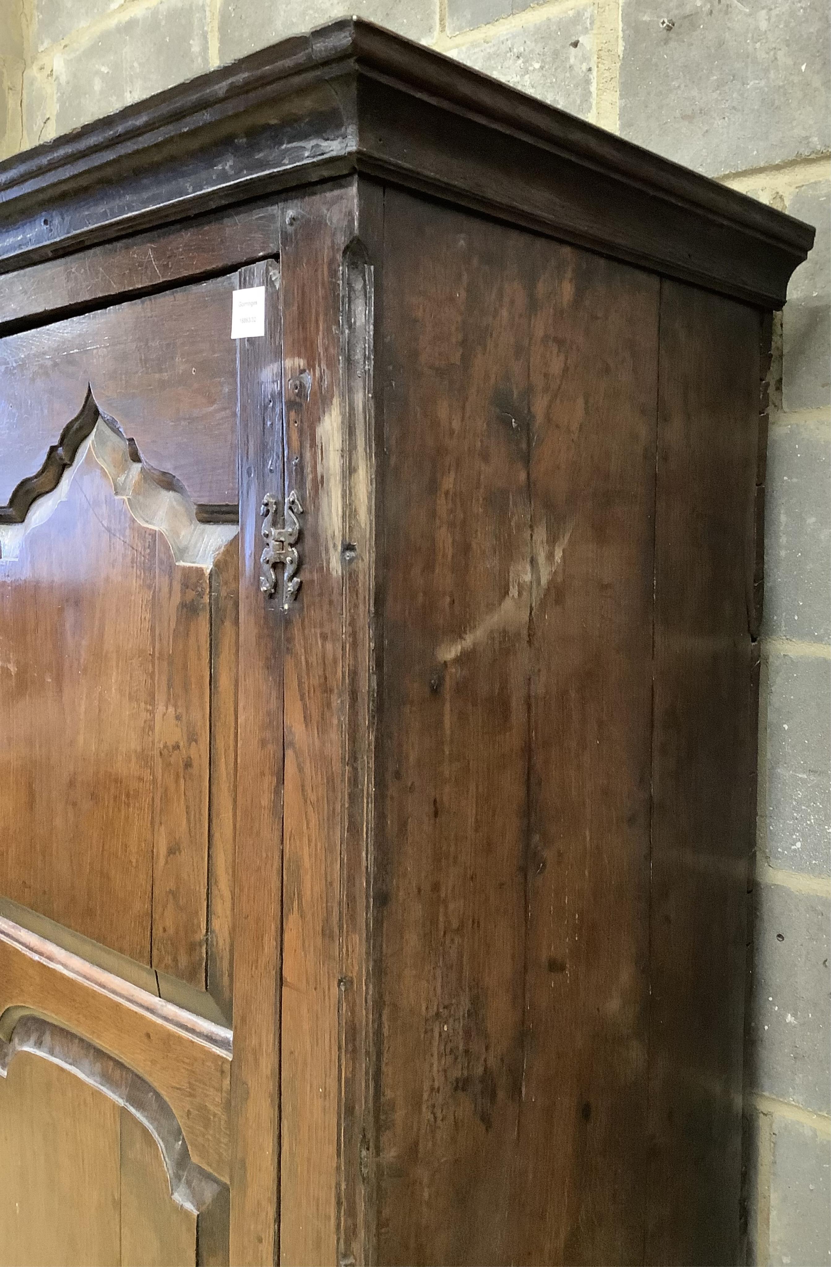 A mid 18th century carved oak cupboard, on associated stand, a.f., width 130cm, depth 55cm, height 178cm. Condition - poor